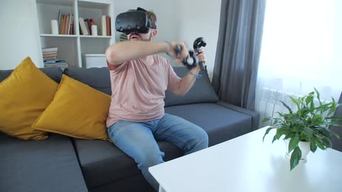 Man Playing Virtual Reality Game at Home