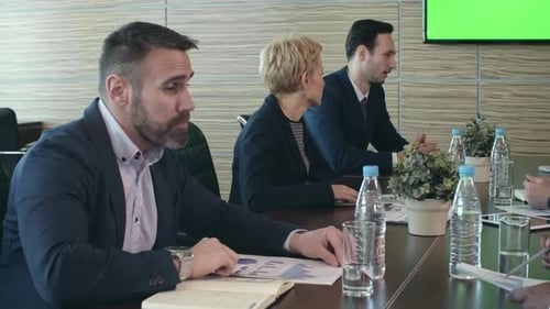 Diverse Group Meeting in Modern Conference Room