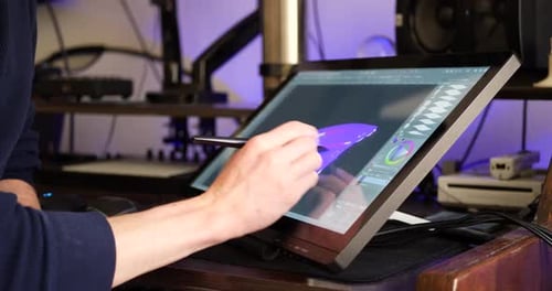 Artist Drawing on Tablet with Stylus at Desk