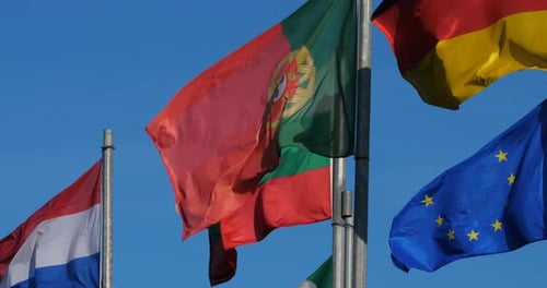 European Country Flags Waving Against Blue Sky