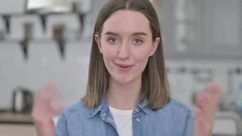 Young Woman Smiling and Talking to Camera