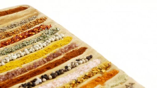 Assorted Colorful Spices Neatly Arranged On Wood Board