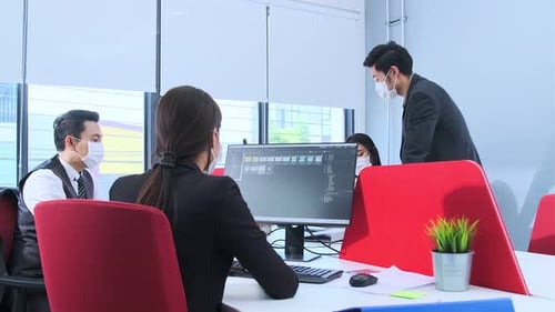 Businesspeople with face masks in the office during COVID-19 pandemic