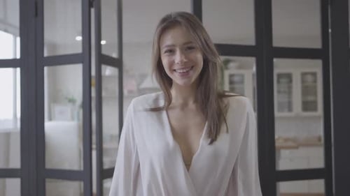 Attractive Woman Smiling Indoors in Modern Home