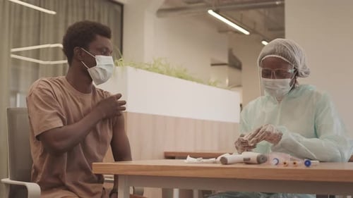 Young Man Receives Injection From Healthcare Professional