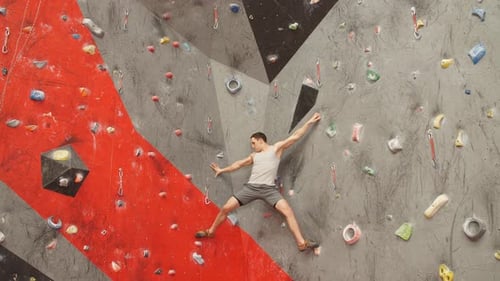 Man Climbing Indoor Rock Wall Workout