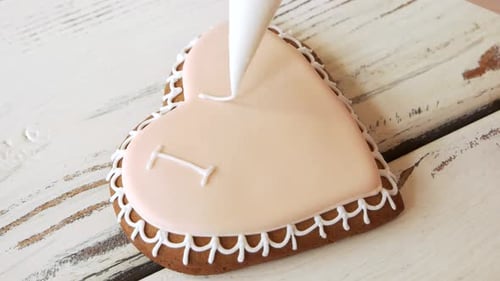 Decorating Heart Shaped Cookie with I Love You Message