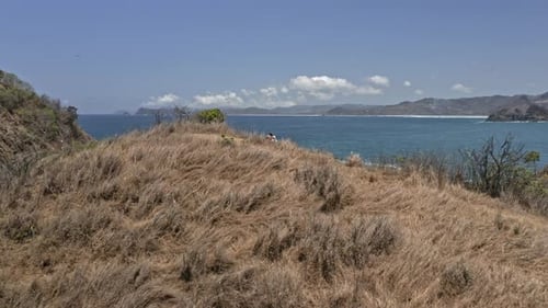 Hikers on Top of Summit Overlooking Lombok Island Waters in Indonesia