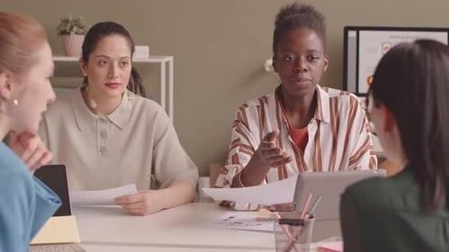 Female Marketing Specialists Working on Project in Office