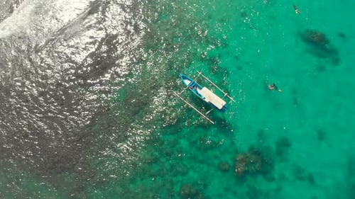 Aerial View of Tropical Beach and Outrigger Boat