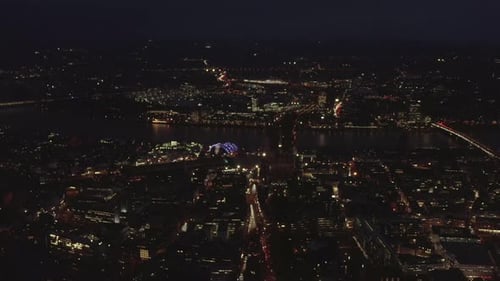 AERIAL: Beautiful Wide Shot Over Cologne Germany at Night Time with City Lights