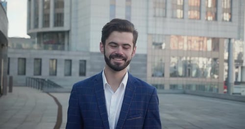 Portrait of Smiling Bearded Man Entrepreneur Outdoors in City Street Looking at Camera