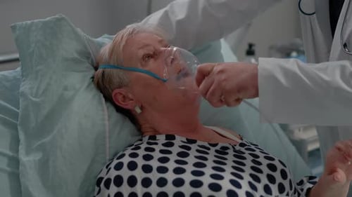 Senior Woman Receiving Oxygen Mask Treatment in Hospital