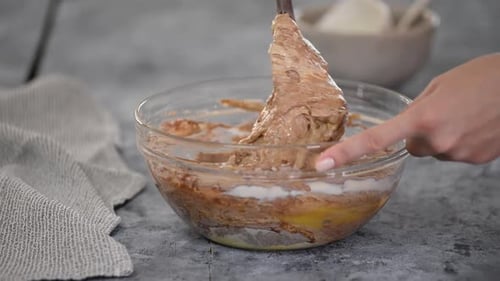 Mixing Batter with Spoon in Glass Bowl