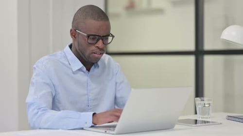 Sick Man Coughing While Using Laptop Computer