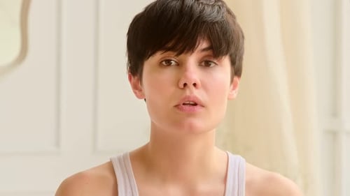Young Woman Posing with Neutral Expression Indoors