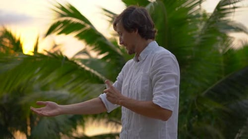 Man Sprays Bug Spray on Arm in Tropics