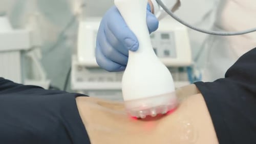 Medical Professional Using Red Light Treatment on Patient