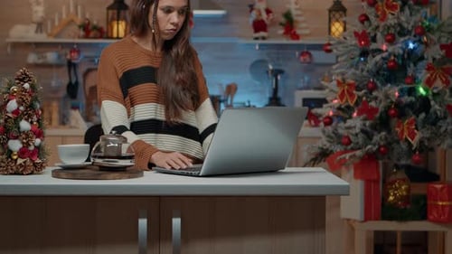 Woman Working on Laptop During Christmas