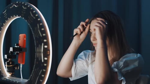 Blonde Mature Woman Beauty Blogger Strokes Her Hair in Front of Ring Light