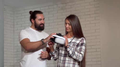 Woman Tries Virtual Reality Headset with Man