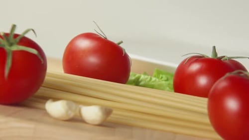 Spaghetti Fall On A Table Between A Ripe Tomatoes