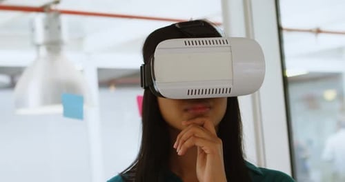 Woman Uses VR Headset in Modern Workplace