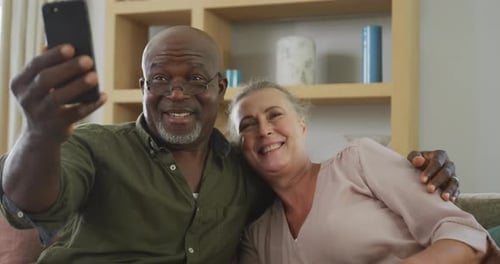 Happy Senior Couple Taking Selfie at Home