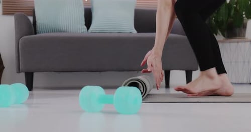 Close up hands of sport woman rolling out yoga mat prepare to work out by exercise.