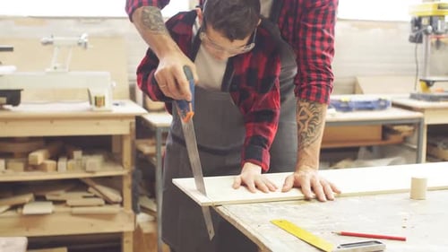 Dad and His Son Are Working in the Workshop