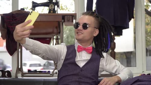 Young Man Taking Selfie in Tailor's Shop