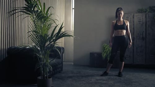 Woman in Workout Room with Phone