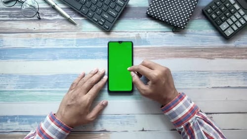 Man's Hand Using Smart Phone Office Stationary Table