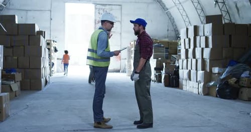 Two Man Discussing in a Warehouse