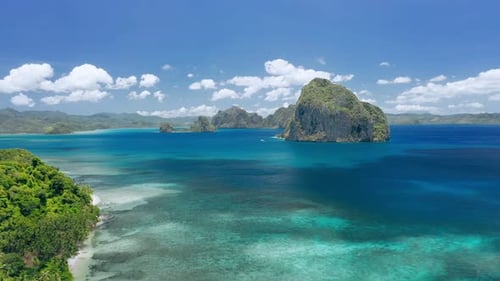Aerial Drone View of Huge Pinagbuyutan Island and Clouds Shadow Moving on Ocean Surface