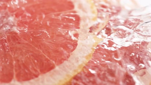 Pink Grapefruit Slices Macro with Refreshing Water Splash