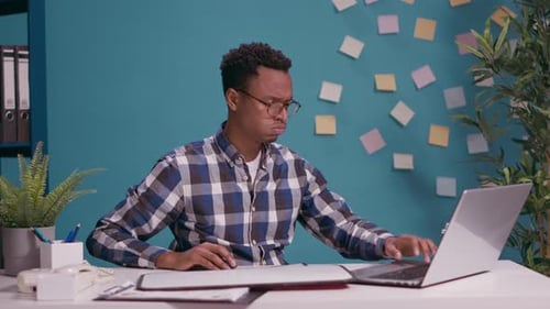 Adult at Desk Holds Help Sign