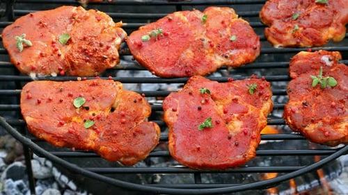 Tasty pork neck with spices on a hot grill
