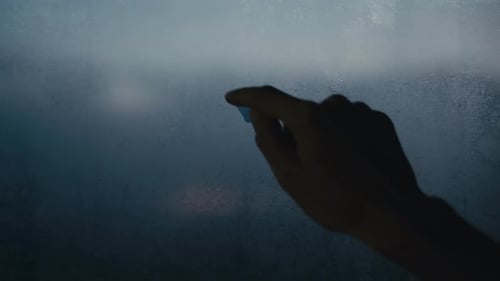 Hand Draws Heart on Foggy Glass Surface