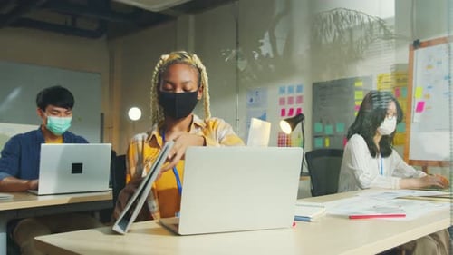 Colleagues Working with Laptops in Office with Masks