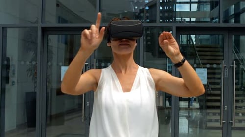 Woman Using VR Headset in Urban Lobby