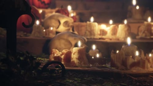 Spooky Halloween Jack-o'-Lanterns and Flickering Candles Scene