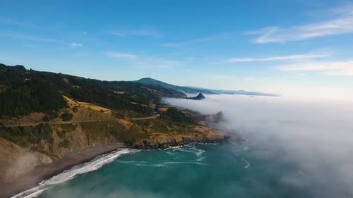 AERIAL: Slow push in on a foggy Oregon coastline.