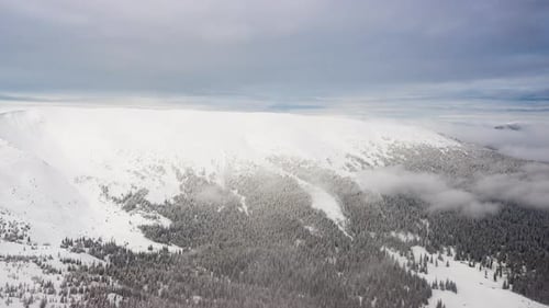 Snowy Mountain Peak in the Clouds