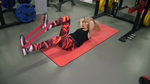 Athletic Woman at the Gym Doing an Exercise on the Press Lying on a Mat Slow Mo