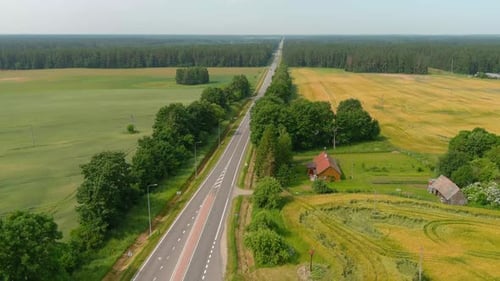 Aerial view rural asphalt road with a beautiful landscape. 4K footage. Drone clips on the Highway in