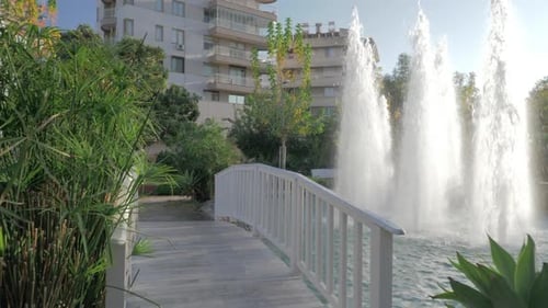 A Steadicam Shot of a Beautiful Pond with Fountains