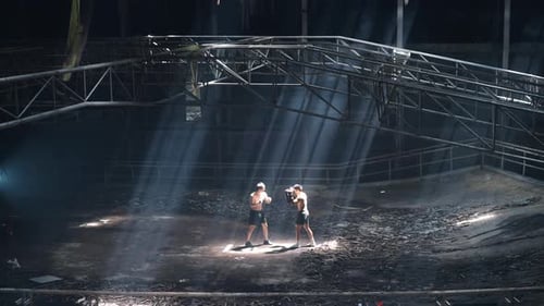 4K Asian man boxer do practicing boxing with male coach in abandoned building.