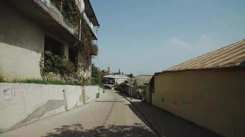 Walk Old Street of Ancient City Signagi, Georgia. Buildings with Tiled Roofs, Vineyards on Balconies