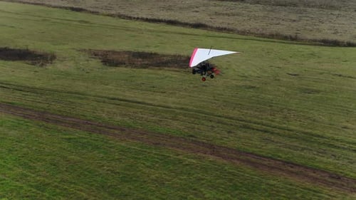 A Hang Glider Is Landing on a Field